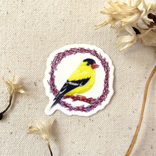 Sticker of a yellow bird surrounded by flowers on a textured beige background
