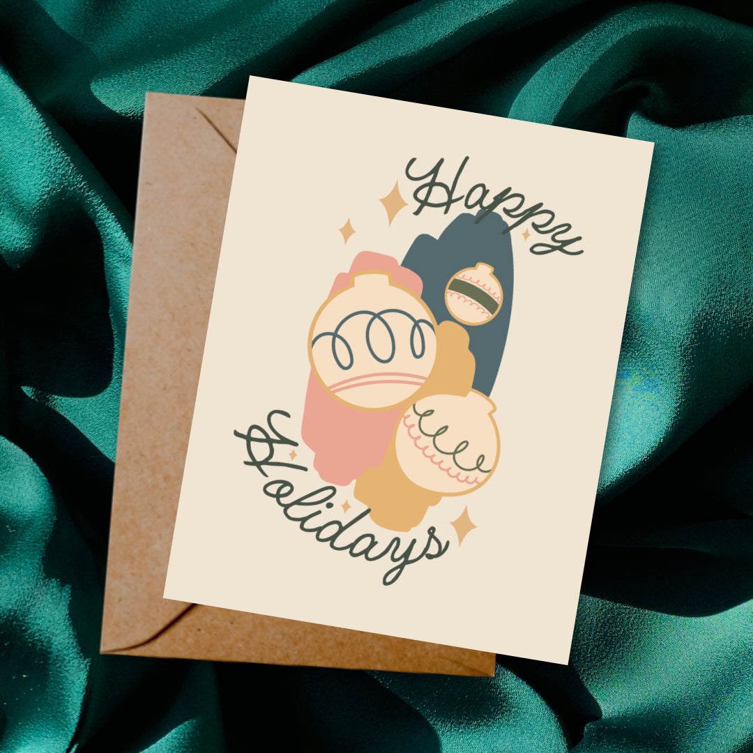 Greeting card and envelope with ornament illustration and 'Happy Holidays' text on a dark background.