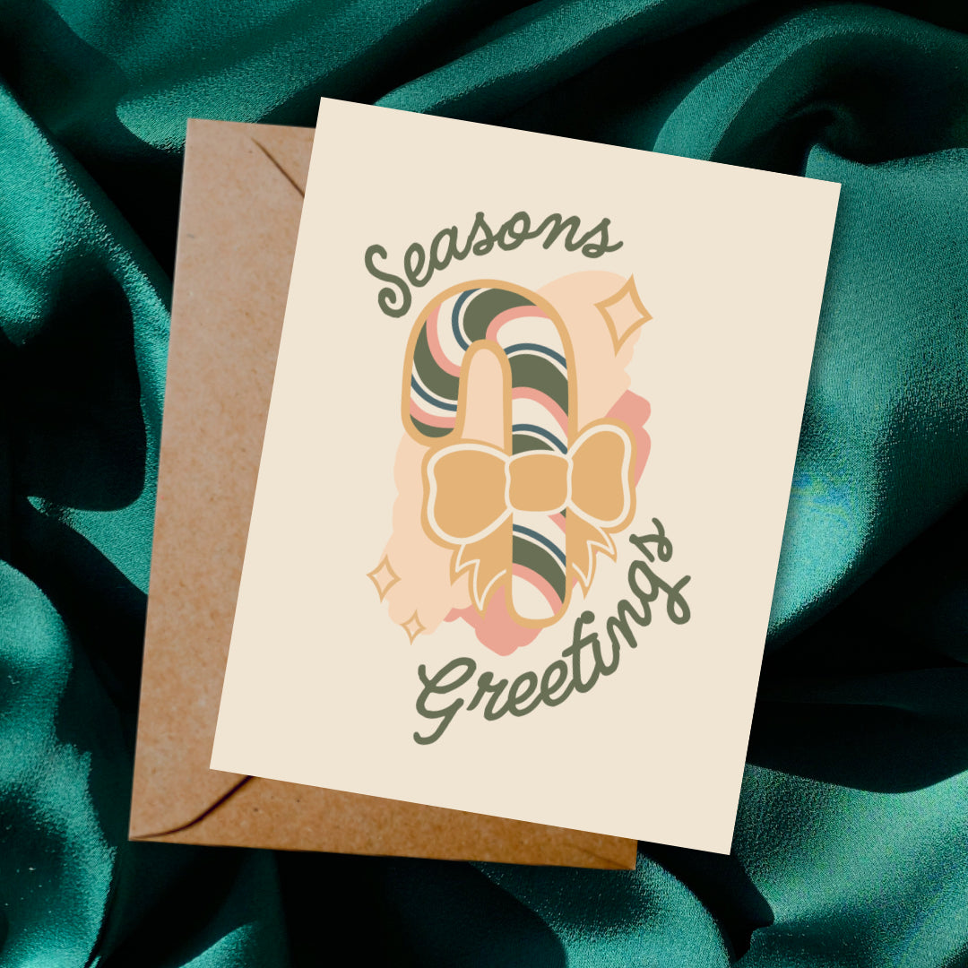 Greeting card and envelope with ornament illustration and 'Season's Greetings' text on a dark background.