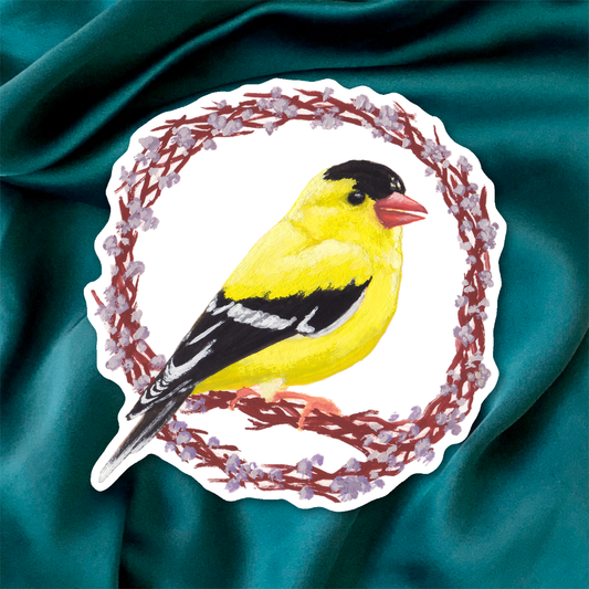 Sticker of a yellow bird with black wings on a textured teal fabric background